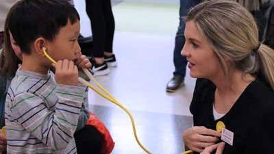 little boy listens to a nurse's stethescope