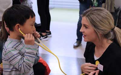 little boy listens to a nurse's stethescope